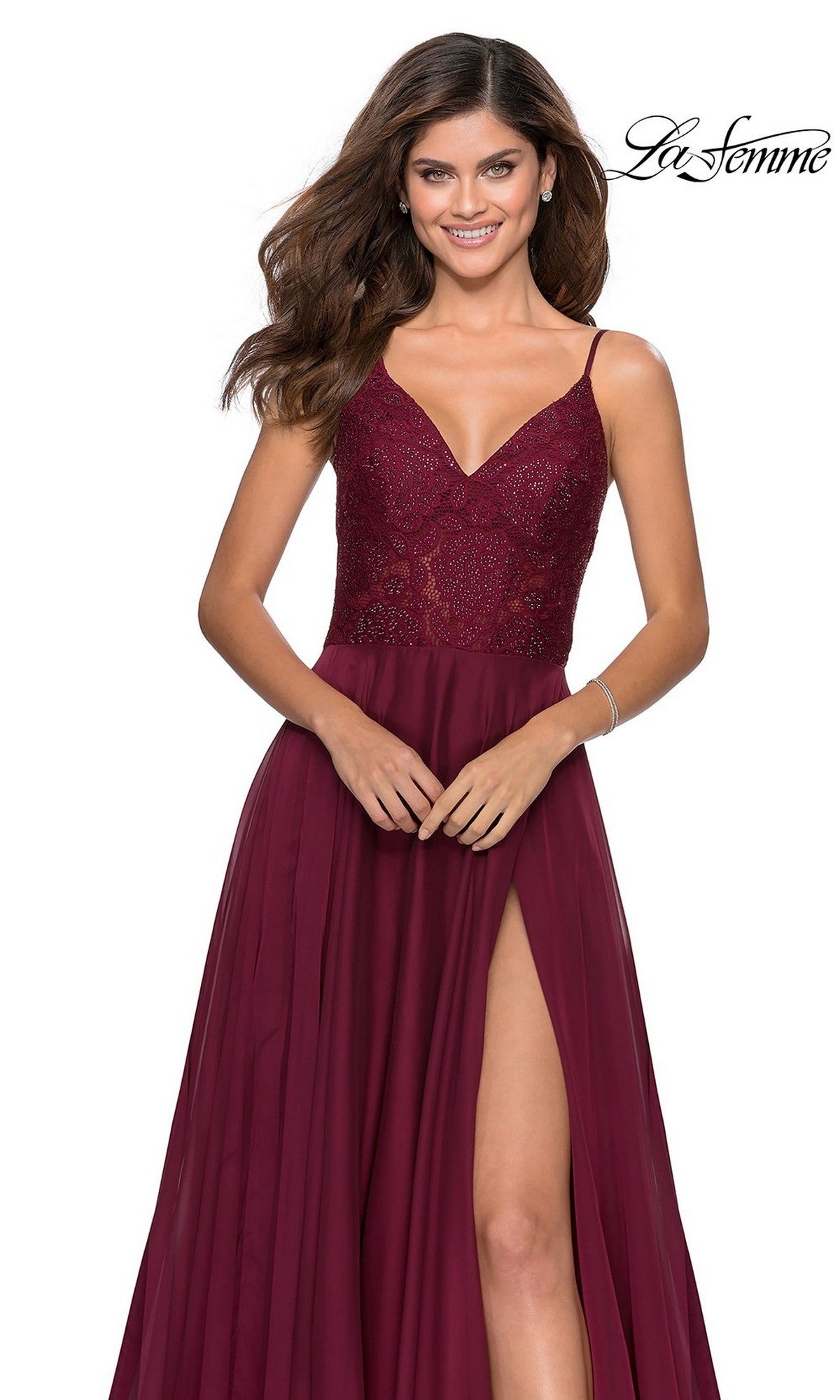 A woman stands and smiles against a white background in the La Femme Sheer-Lace-Bodice Long Prom Dress 28664, featuring a long A-line skirt, sheer embroidered-lace bodice, and thigh-high slit.